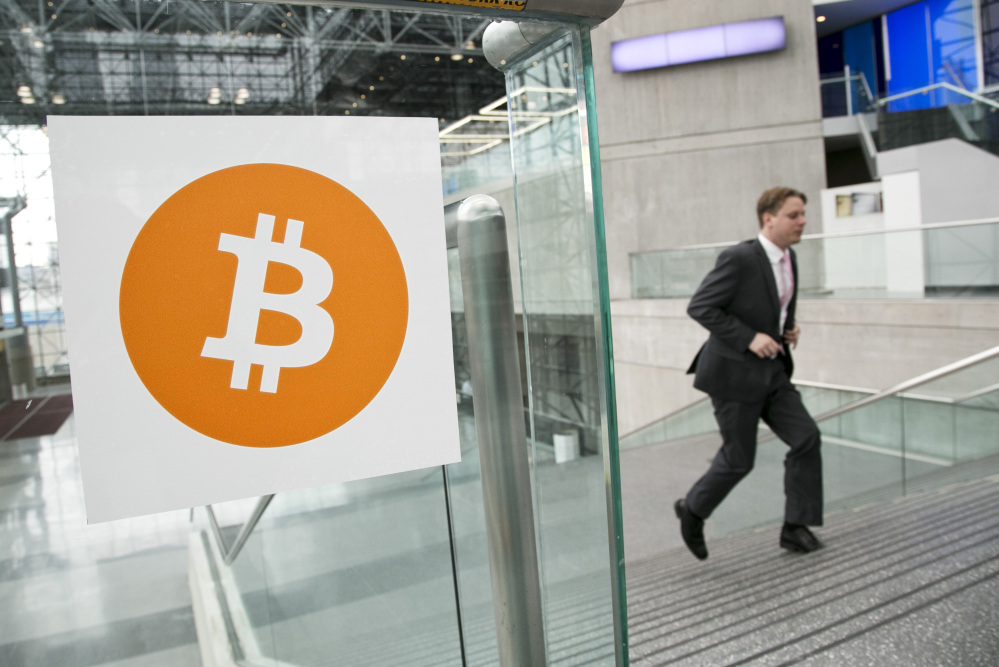 In this April 7, 2014 file photo, a man arrives for the Inside Bitcoins conference and trade show in New York. An Australian man long thought to be associated with the digital currency Bitcoin has publicly identified himself as its creator. BBC News said Monday, May 2, 2016 that Craig Wright told the media outlet he is the man previously known by the pseudonym Satoshi Nakamoto. The computer scientist, inventor and academic says he launched the currency in 2009 with the help of others. 