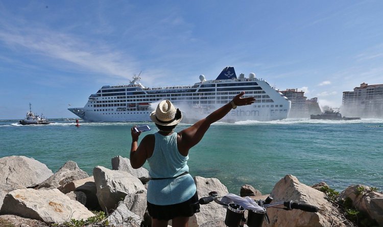 A woman from Cuba waves Adonia leaves port in Miami en route to Cuba. 