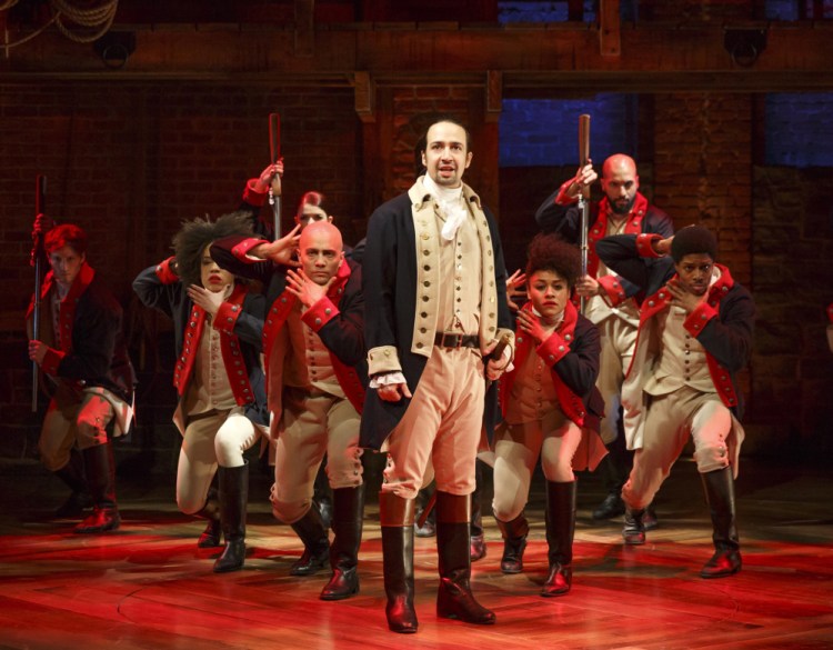 This image released by The Public Theater shows Lin-Manuel Miranda, foreground, with the cast during a performance of "Hamilton," in New York.