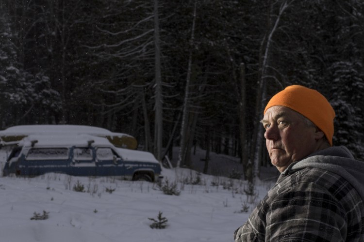 Carter McBreairty stands outside his Allagash home near dusk. Unaware that a visitor to the area was an undercover agent, McBreairty allowed the man who was investigating him to stay in his house for days, even when McBreairty was at his construction job in midcoast Maine.