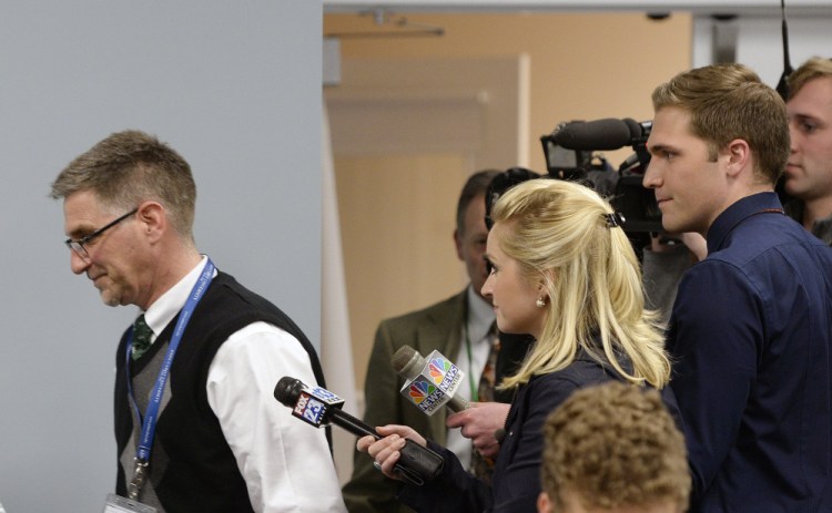 Superintendent Frank Sherburne walks past the media without comment Monday at a school board meeting where he came under fire from residents concerned about his leadership of SAD 6.