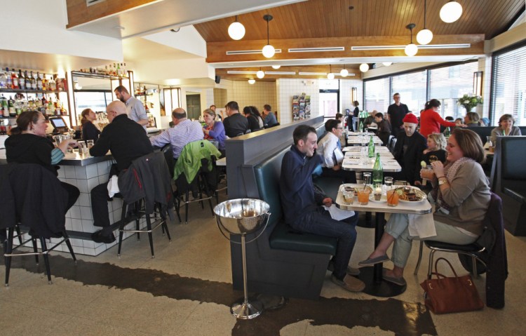 The dining room and bar at Woodford Food & Beverage. Jill Brady/Staff Photographer