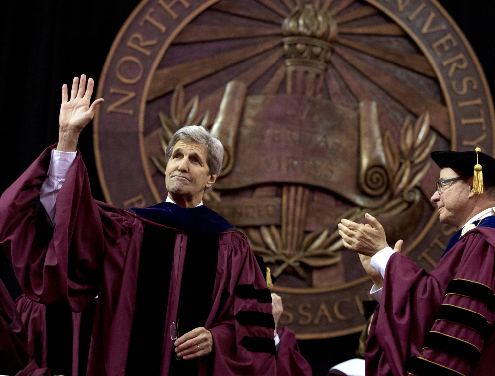 Secretary of State John Kerry acknowledges the crowd after delivering the keynote address during Northeastern University's commencement Friday as Northeastern president Joseph E. Aoun looks on.