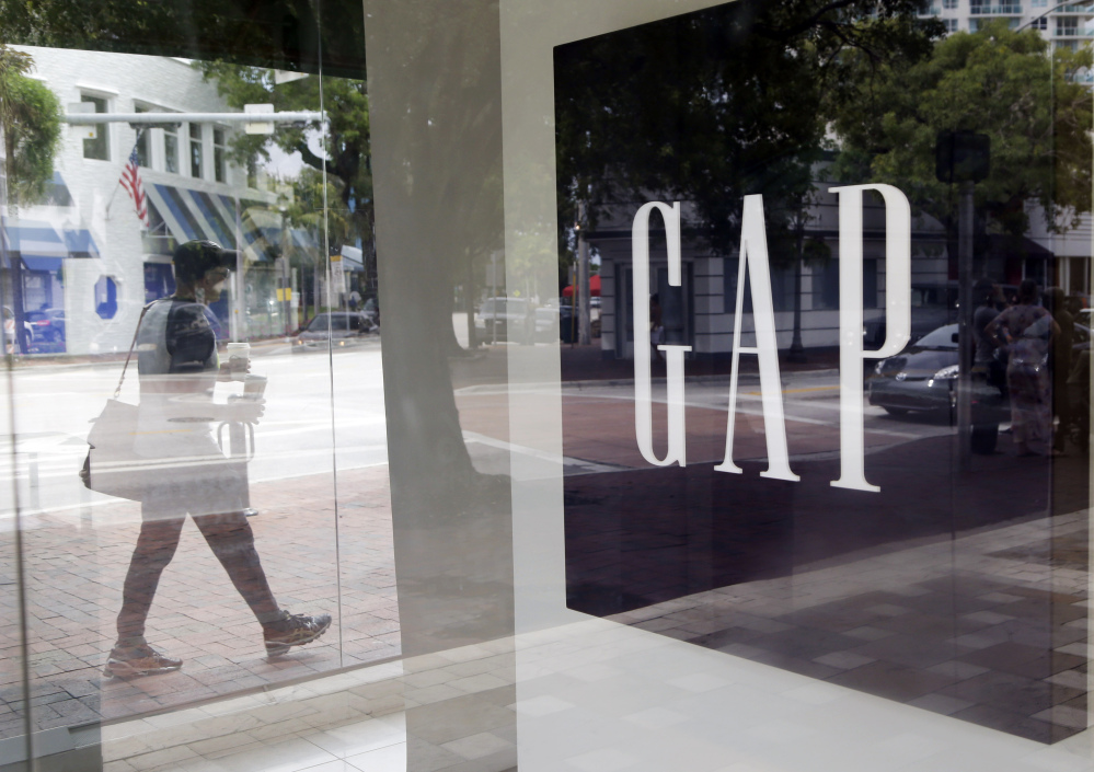 A pedestrian walks past a Gap store in Miami. Gap said Thursday that it plans to close 75 Old Navy and Banana Republic stores outside North America.