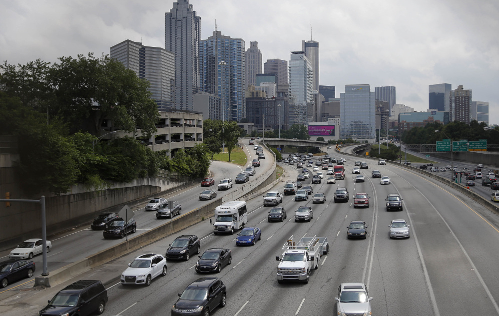 Traffic flows in and out of downtown Atlanta on Thursday. The travel group AAA predicts 38 million people will take a trip on Memorial Day weekend, the most since 2005.