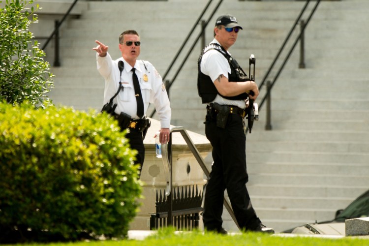 A Secret Service agent orders people inside after another agent shot a man who approached with a weapon just outside the White House. 