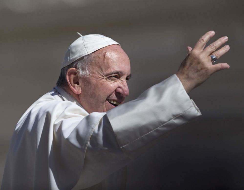 Pope Francis greets the crowd as he arrives for his weekly general audience in St. Peter's Square at the Vatican on Wednesday.
The Associated Press