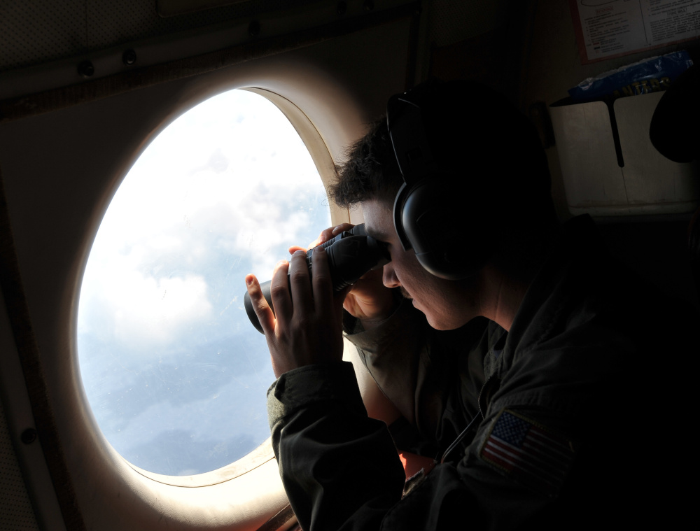 U.S. Navy Lt. j.g. Dylon Porlas looks out from a Lockheed P-3C Orion patrol aircraft Sunday over the area where the EgyptAir flight crashed.