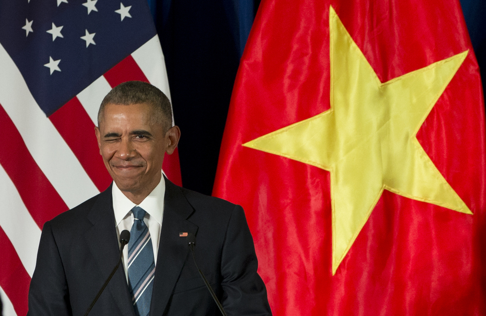 President Barack Obama winks as he arrives for a news conference with Vietnamese President Tran Dai Quang Monday at the International Convention Center in Hanoi, Vietnam.