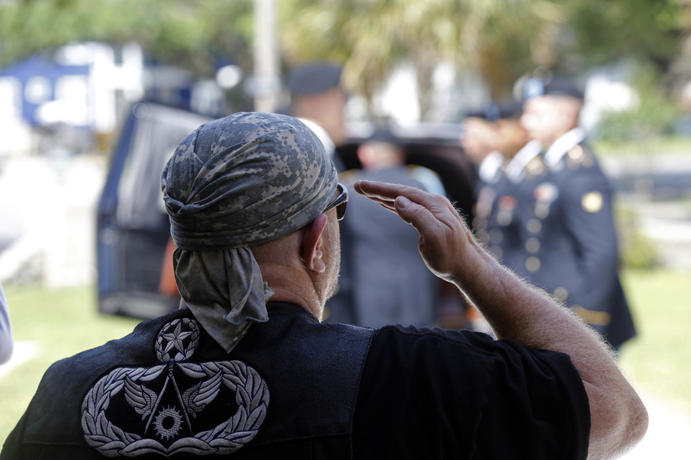 Chuck Gill, of Albany, La., representing the Patriot Guard Riders, salutes as the casket containing remains of Army Pvt. Earl Joseph Keating as it arrives at the Schoen Funeral Home in New Orleans on Monday.