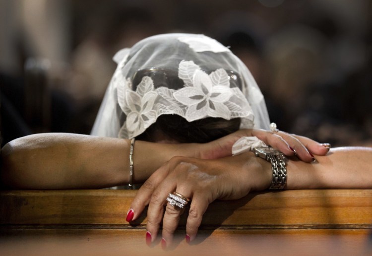 A Coptic Christian woman grieves during prayers for the departed Sunday, remembering the victims of Thursday's crash of EgyptAir flight 804, at Al-Boutrossiya Church, the main Coptic Cathedral complex, in Cairo, Egypt.