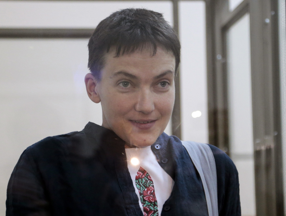 Nadezhda Savchenko smiles at journalists from a glass cage in court, in Donetsk, Rostov-on-Don region. Russian President Vladimir Putin announced Wednesday that he will pardon the Ukrainian pilot.