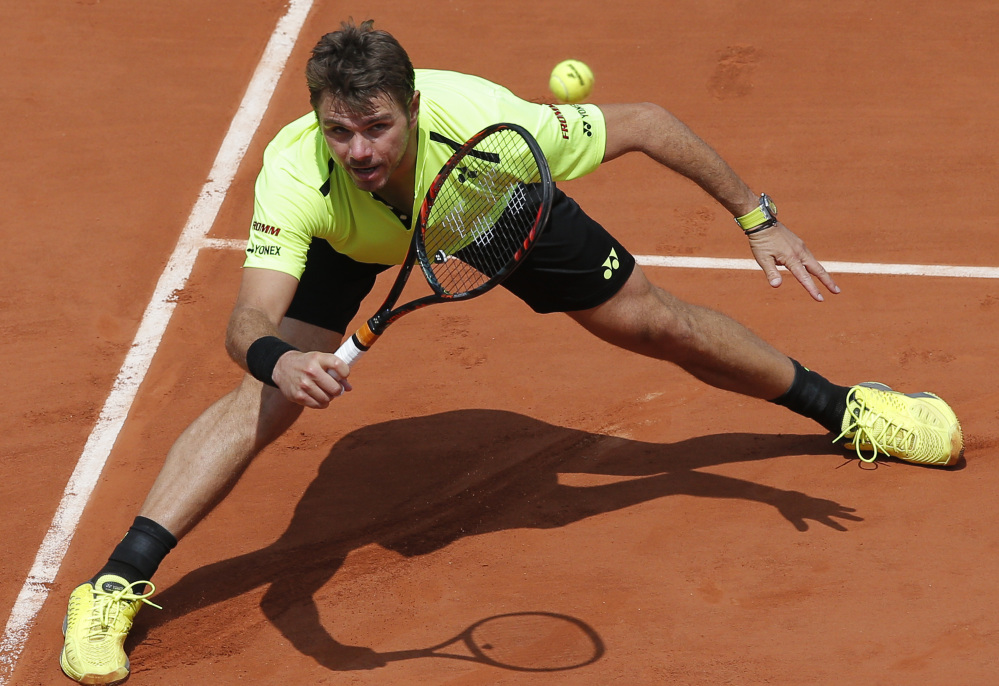 Stan Wawrinka of Switzerland returns the ball to  Taro Daniel of Japan during their second-round match at the French Open on Wednesday in Paris. The reigning champ, Wawrinka won, 7-6 (9-7), 6-3, 6-4.