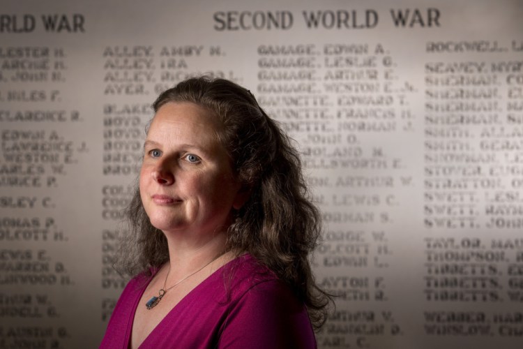 Posing near the Veterans Wall in the Southport Memorial Library, Sarah Sherman McGrail says she has collected 228 stories from Korean and Vietnam war veterans from the Boothbay region. 