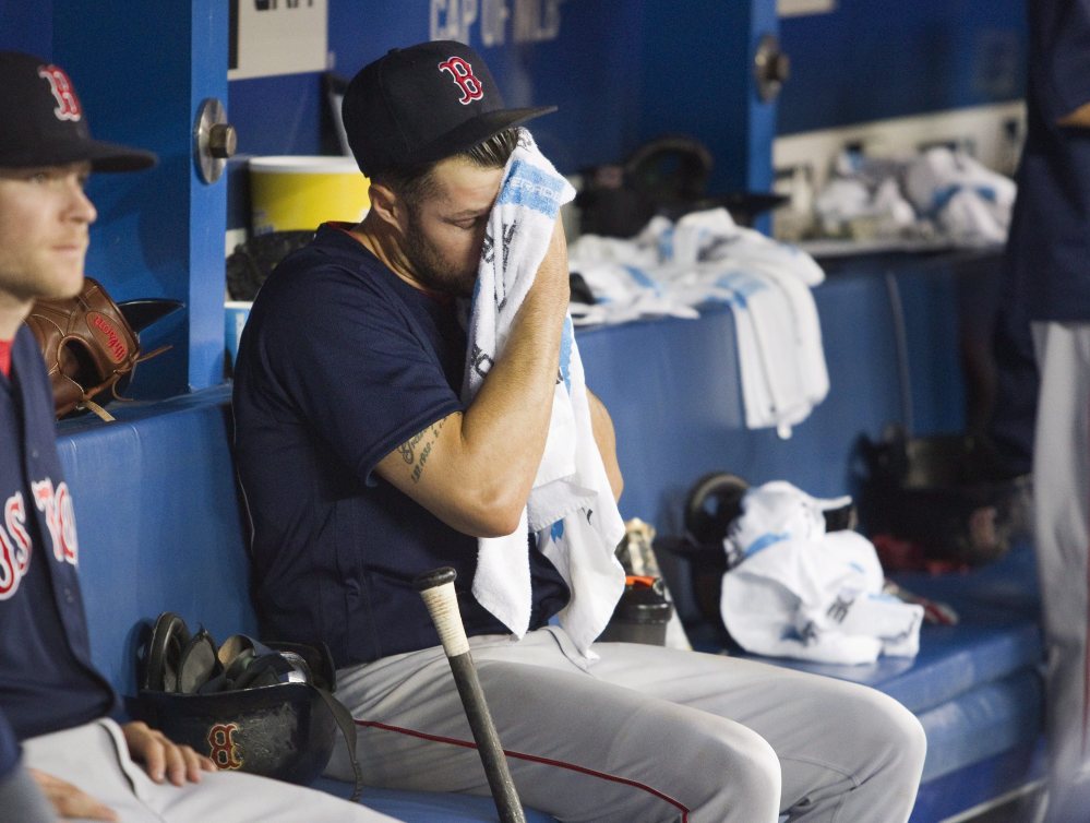 Red Sox starter Joe Kelly sits in the dugout in the fifth inning after being taken out of Friday's game against the Blue Jays at Toronto.