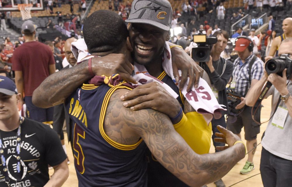 LeBron James, right, and J.R. Smith celebrate after the Cavaliers beat the Toronto Raptors in Game 6 to win the Eastern Conference finals on Friday in Toronto. Cleveland has been on a roll since a team meeting on March 25.