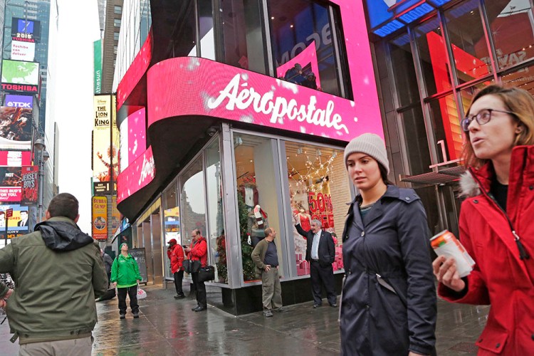 Women pass Aeropostale clothing store, Wednesday, Dec. 2, 2015, in New York's Times Square. The clothing retailer reports quarterly earnings Wednesday. (AP Photo/Mark Lennihan)