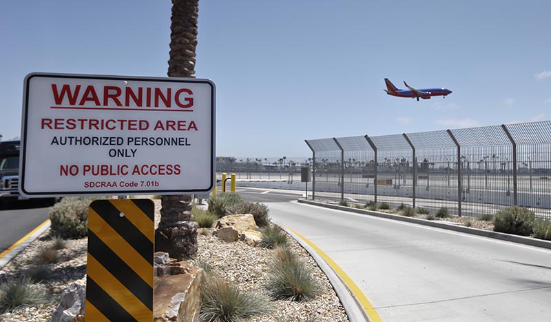 San Diego International Airport, where multiple layers of fencing topped with razor wire protect the airport grounds. 