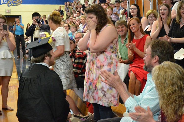 Timothy Babine proposes to his girlfriend, Hayley Hamilton, during commencement exercises at the  University of Maine at Presque Isle.
