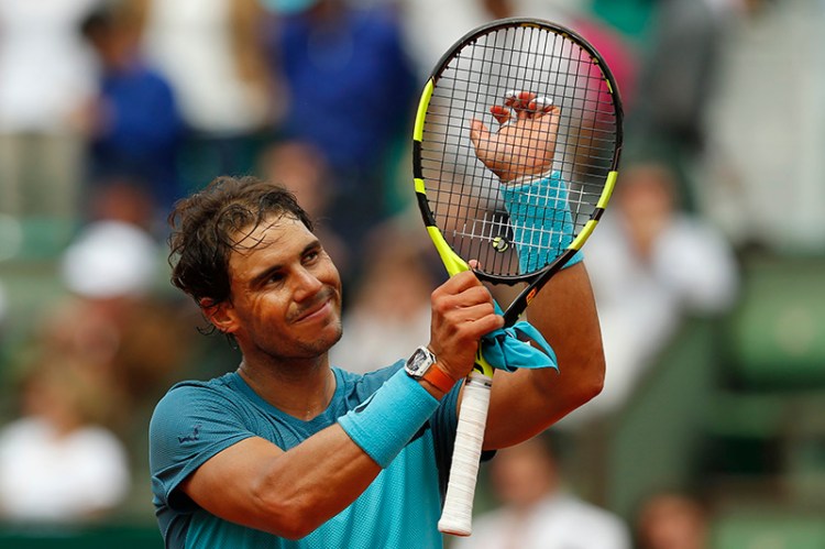 Rafael Nadal acknowledges cheering spectators after winning his second round match of the French Open.