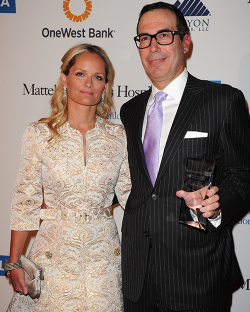 Steven Mnuchin, seen here with his wife Heather Mnuchin in a 2013 photo, has been hired as national finance chairman for the Trump presidential campaign. Steven Mnuchin is  a New York investor with ties in Hollywood and Las Vegas but no previous political fundraising experience. Invision via AP