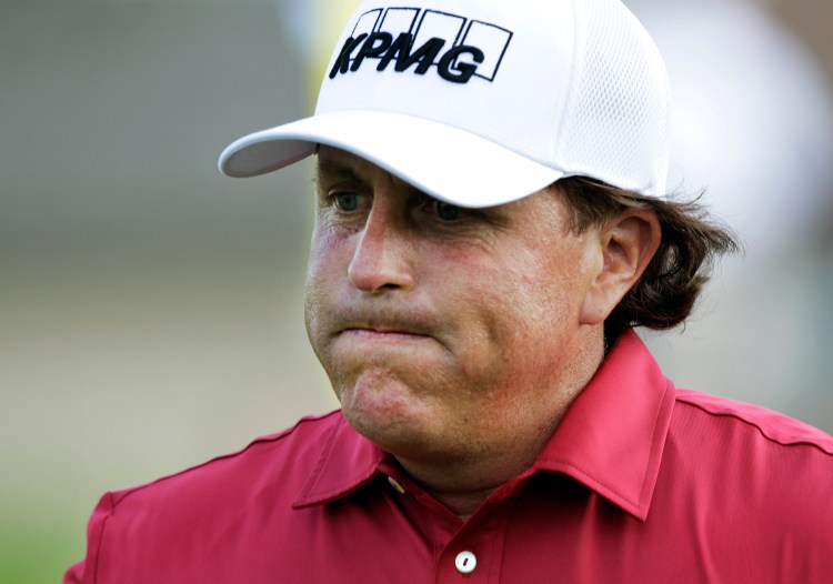 Phil Mickelson reacts after making double bogey on the 17th hole during a round of the Memorial Golf Tournament in Dublin, Ohio, on May 29, 2014. Mickelson confirms that FBI agents questioned him after he finished the round. The Associated Press