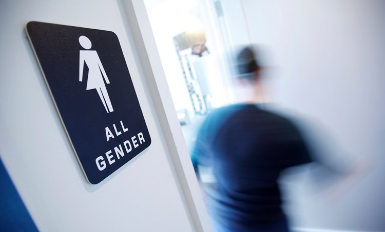 A bathroom sign welcomes both genders at the Cacao Cinnamon coffee shop in Durham, North Carolina. The shop installed the signs after North Carolina's "bathroom law" gained national attention, positioning the state at the center of a debate over equality, privacy and religious freedom.  — Reuters