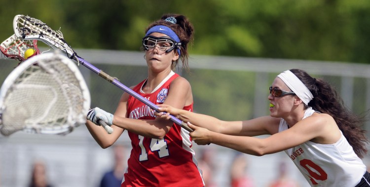 Gardiner's Bryce Smith, right, blocks Messalonskee's India Languet during a lacrosse game Wednesday in Gardiner.
