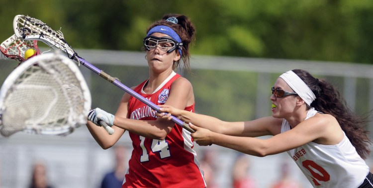 Gardiner's Bryce Smith, right, blocks Messalonskee's India Languet during a lacrosse game Wednesday in Gardiner.