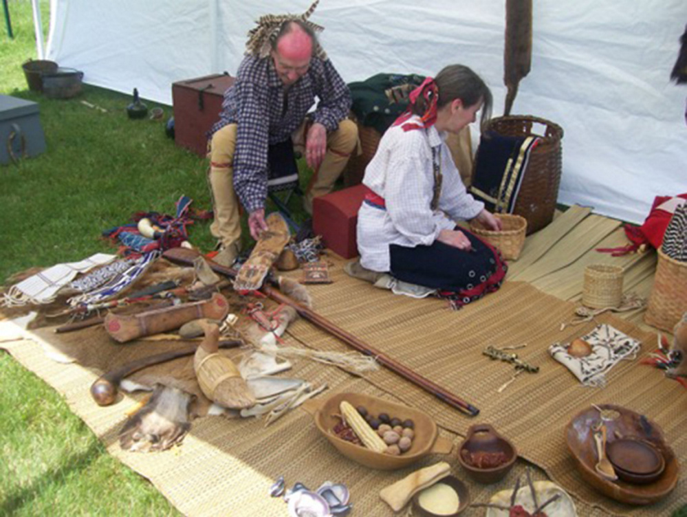 Jeff and Gail Usher prepare their Native American display at the Chapman-Hall House for the Three Traditions program.