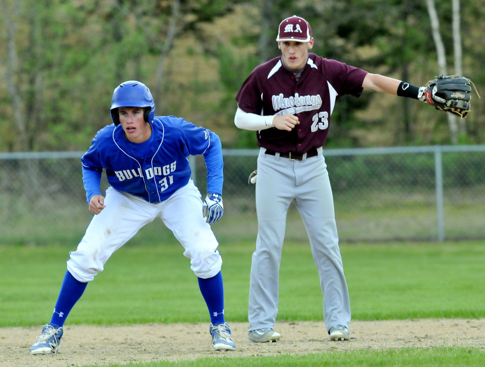 Monmouth shortstop Hunter Richardson, right, calls for a pickoff attempt at second base as Madison runner gets his lead during a game last month. The Mustangs (16-0) enter the Class C South playoffs as the No. 1 seed. The Bulldogs (14-2) are the No. 3 seed.