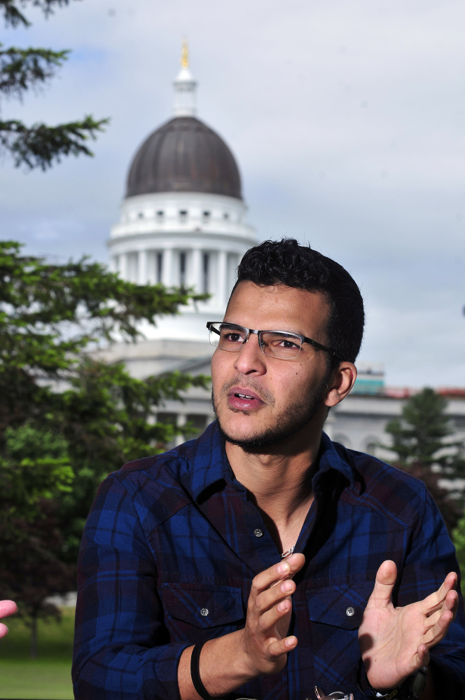 Ahmed Al Abbas answers questions during an interview on Thursday in Augusta's Capital Park. Al Abbas, an immigrant from Iraq, graduated from Augusta Adult and Community Education on Friday. Staff photo by Joe Phelan