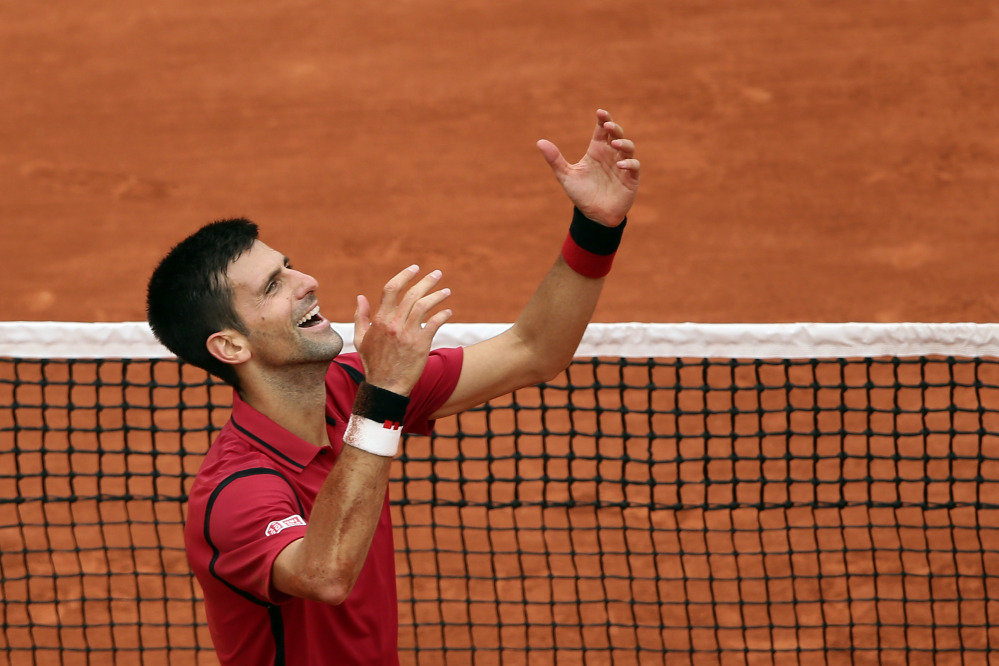 Novak Djokovic raises his arms after defeating Andy Murray 3-6, 6-1, 6-2, 6-4 in the men's final at the French Open on Sunday at the Roland Garros stadium in Paris.