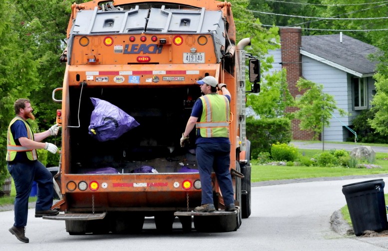 Waterville Public Works employees pick up trash in 2015 in the city. Waterville officials have decided against signing on with a proposed waste-to-energy plant planned for Hampden and instead will send city trash to the Crossroads landfill in Norridgewock for the next five years.