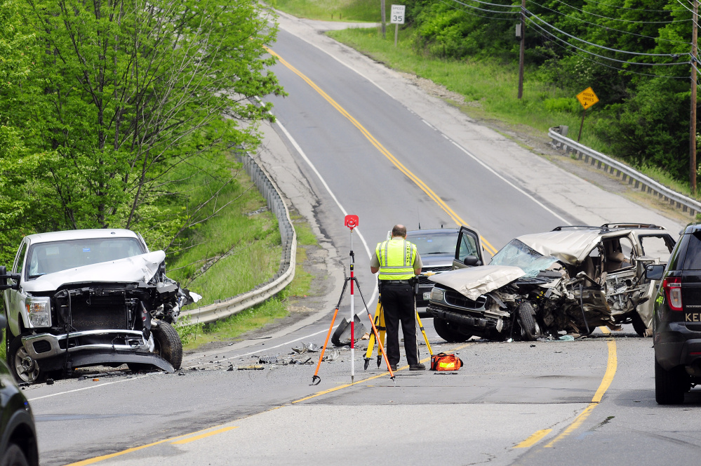 Officials work at the scene of a fatal two-vehicle crash on Tuesday on Western Avenue, also called U.S. Route 202, in Manchester near the Augusta line.