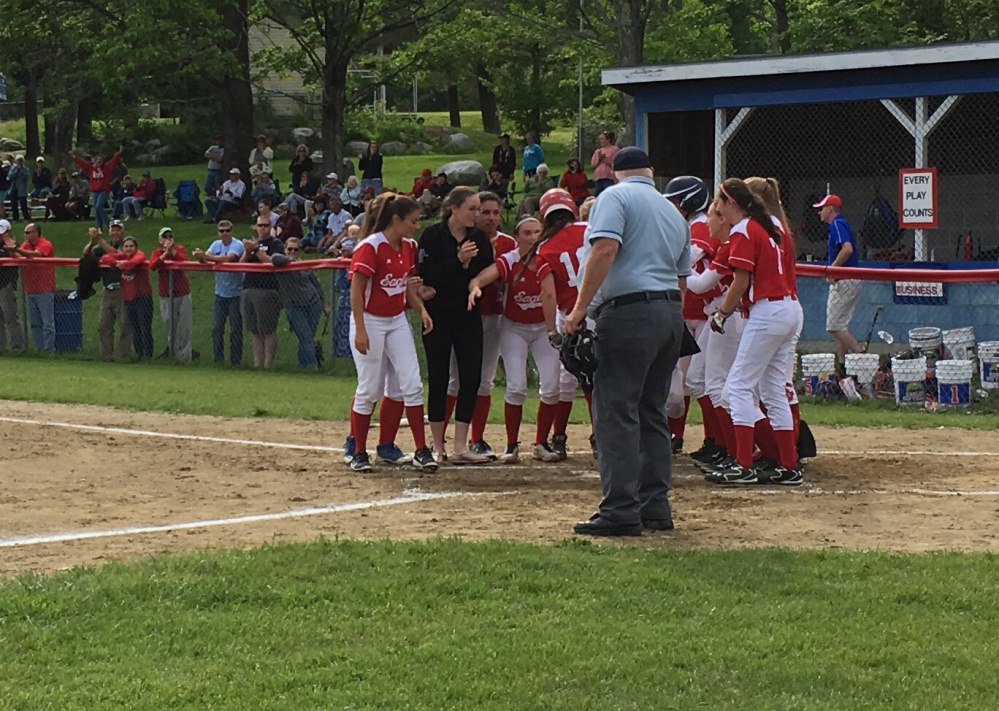 Members of the Messalonskee softball team greet Katie Guarino at home plate after she belted a home run in the bottom of the fifth inning of a Class A North quarterfinal game against Mt. Ararat. The homer stood as the only run of the game.