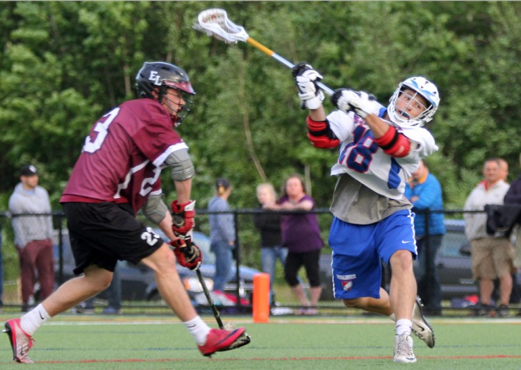 Messalonskee's Alden Balboni, right, fires a shot as Edward Little defender Ben Steele closes in during the first half of a Class A North quarterfinal at Thomas College in Waterville on Wednesday.