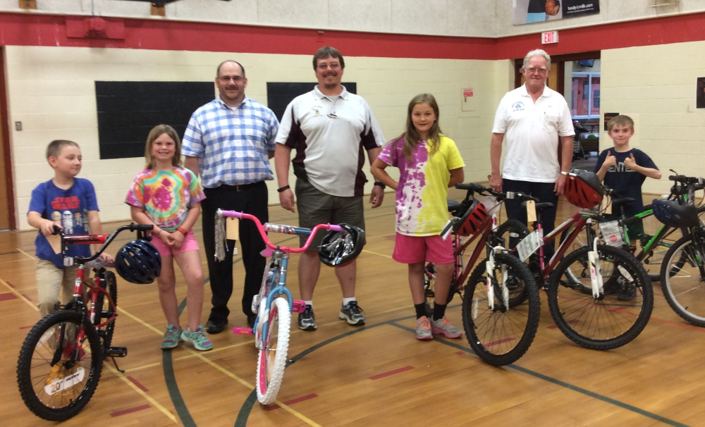 The Oakland Masons held their Books for Bikes drawings recently. From left are the students who won bikes with the masons who drew their names, Simon Pelletier, Hannah Phair, Travis Wood, Jeremy Kaherl, Ashley Mullen, Dana Wrigley and Ethan Glueck. Students who read books at their reading level. For each book read, students were able to enter for a chance to win a bike. ​There were eight students who won a new bike, helmet and T-shirt. All students received a bookmark celebrating reading. ​Those who names were drawn to win bikes were Simon Pelletier, Hannah Phair, ​Ashley Mullen ​and Ethan Glueck. Travis Wood, Jeremy Kaherl, and Dana Wrigley are the Mason ​s​ represented.