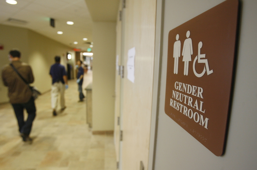 FILE- In this Aug. 23, 2007 file photo, a sign marks the entrance to a gender neutral restroom  at the University of Vermont in Burlington, Vt. For opponents of transgender rights, a favorite line of attack is to oppose policies that would allow people to choose whether to use a men's or women's bathroom based on gender identity.(AP Photo/Toby Talbot, File)