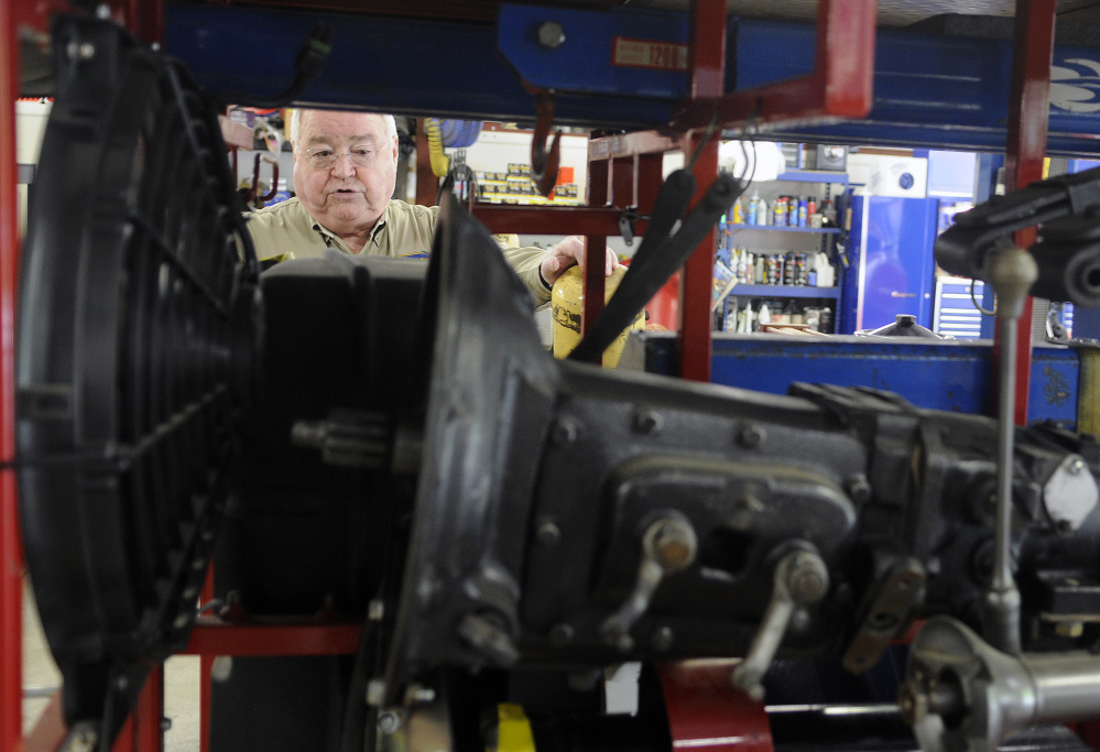 At his Gardiner garage on Thursday, Peter Prescott inspects the extra engine and auto components that will accompany his team and car across the western United States during the 2016 Hemmings Motor News Great Race.