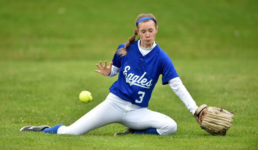 Staff photo by Michael G. Seamans 
 Messalonskee's Makenzie Cherest misses a fly ball hit by Edward Little's Kylie Bureau during a Class A North semifinal game Saturday in Oakland.