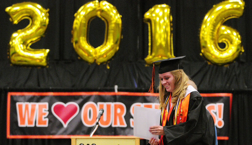 Cassie Trask returns to her seat Saturday after winning a scholarship during the Gardiner Area High School graduation at the Augusta Civic Center.