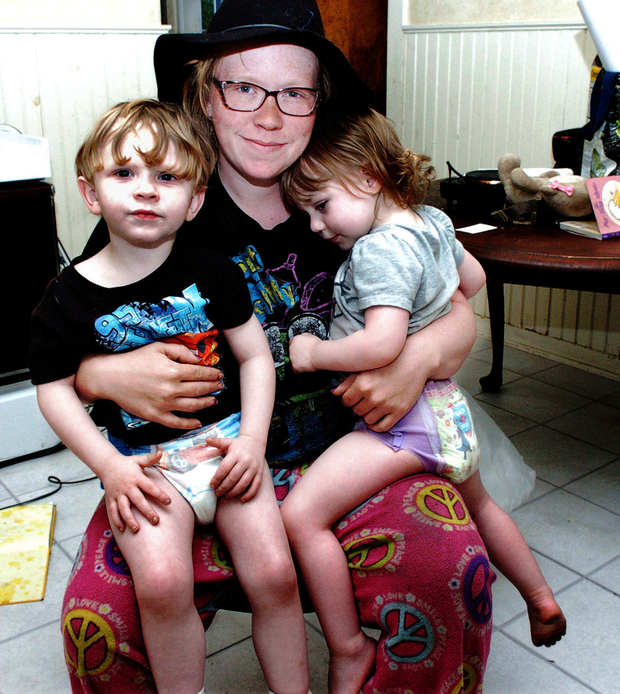 Melissa Blodgett with two of her children, Caspian, left, and Emilia, at their apartment in Winslow on Sunday.