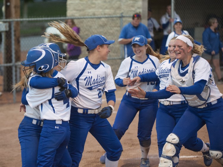 Members of the Madison softball team celebrate after they blanked Lisbon 12-0 in the Class C South title game Tuesday night at St. Joseph's College.
