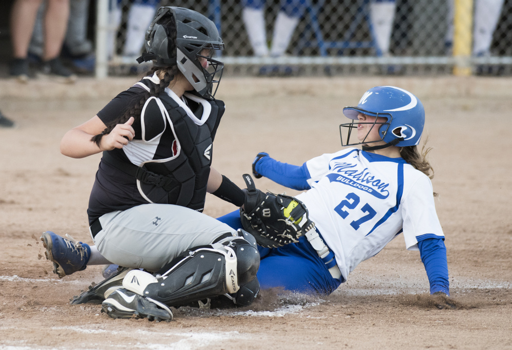 Madison's Erin Whalen is tagged out by Lisbon catcher Jasmin Le during the third inning of the the Class C South final Tuesday night at St. Joseph's College.
