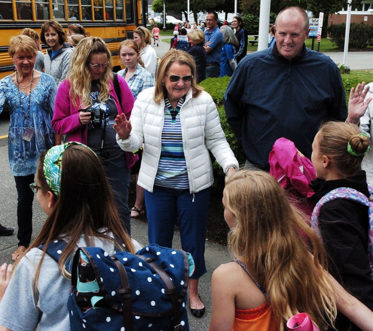 Benton Elementary School Principal Suanne Giorgetti, center, shares the limelight with students as they say goodbye to her Tuesday, their last day of school and the last day of her 39 years as an educator. At right is Assistant Principal David Packard.