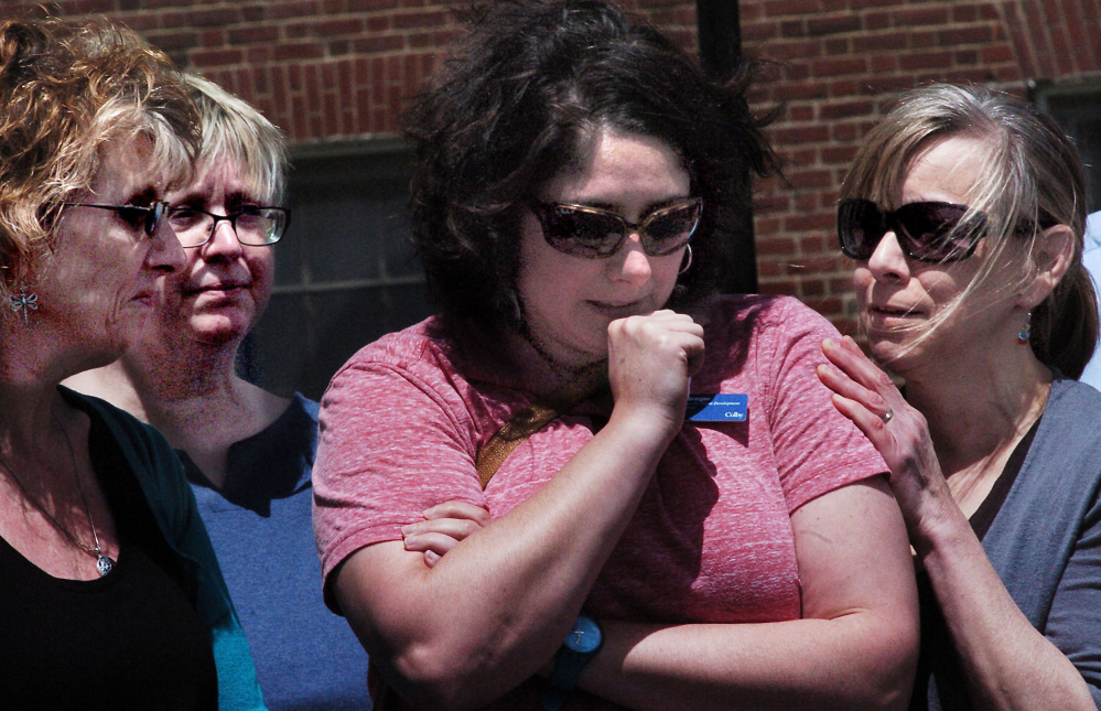An emotional Melissa Breger, center, is consoled by Elizabeth Sagaser, right, and Cathy Langlois, far left, after speaking Wednesday at a vigil at Colby College for victims of Sunday's Orlando shooting.