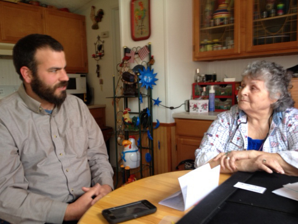 Rep. Jeff McCabe talks to Skowhegan resident Jan Martin on Tuesday in her home about her mold problem and the difficulty she's had getting help.