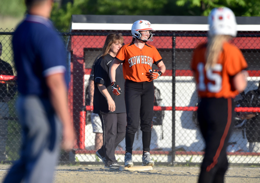 Skowhegan sophomore Ashley Alward stands on first base after drawing a walk during the Class A North title game against Edward Little on Tuesday night in Augusta.