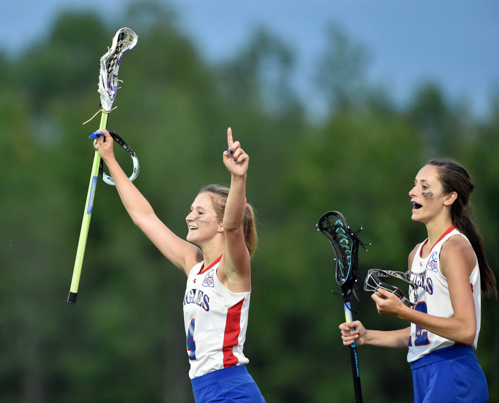 Messalonskee's Emily Hogan (4) holds her hands in the air to celebrate after defeating Lewiston 9-4 in the Class A North championship game Wednesday at Thomas College in Waterville.